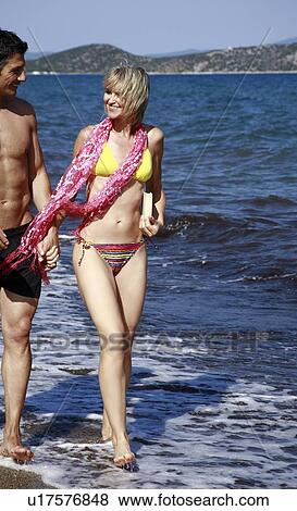 Stock Photo - Mature adult couple on beach. Fotosearch