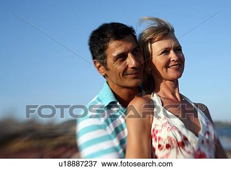Stock Photo - Mature adult couple on beach. Fotosearch