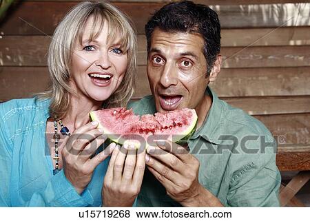 Stock Photo - Mature adult couple with watermelon. Fotosearch