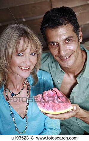 Stock Photo - Mature adult couple with watermelon. Fotosearch
