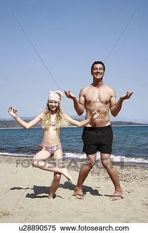 Stock Photography - Father and daughter on beach. Fotosearch