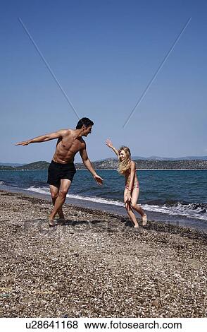 Father and daughter playing on beach View Large Photo Image Stock Photo - Father and daughter playing on beach. Fotosearch