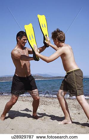 Father and son playing with swim flippers View Large Photo Image Stock Photo - Father and son playing with swim flippers. Fotosearch