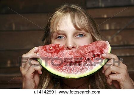 Stock Image - Girl posing with watermelon. Fotosearch