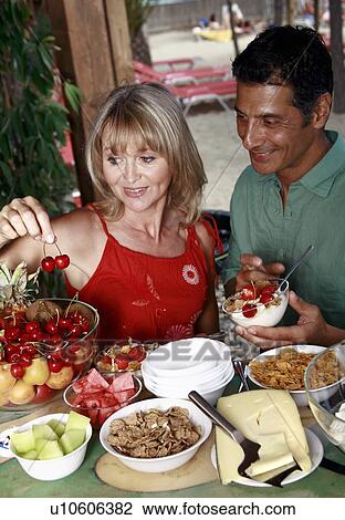 Mature adult couple eating breakfast View Large Photo Image Stock Image - Mature adult couple eating breakfast. Fotosearch