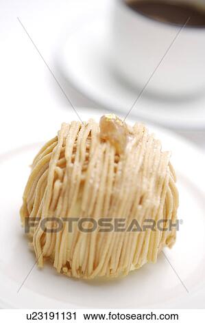 Stock Image - Cake on plate with cup pf coffee aside. Fotosearch