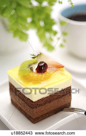 Stock Image - Cake with spoon on plate. Fotosearch
