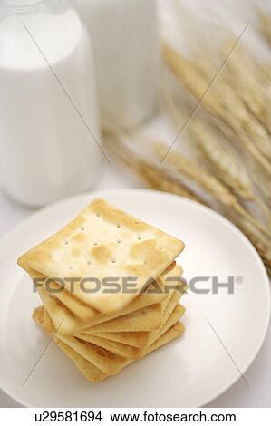 Picture - Crackers on plate by wheat. Fotosearch