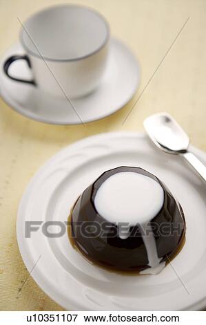 Stock Photo - Jelly on plate with a cup aside. Fotosearch