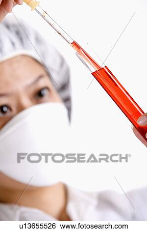 Stock Photograph - Female chemist working with test tube. Fotosearch