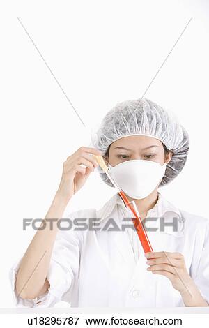 Female scientist filling red liquid into test tube with syringe View Large Photo Image Stock Photo - Female scientist filling red liquid into test tube with syringe. Fotosearch
