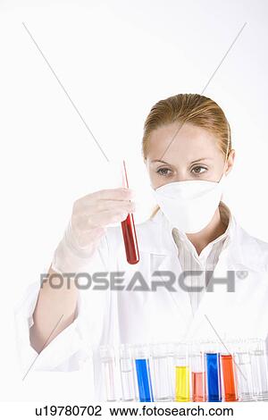 Female scientist holding test tube with liquid View Large Photo Image Stock Image - Female scientist holding test tube with liquid. Fotosearch