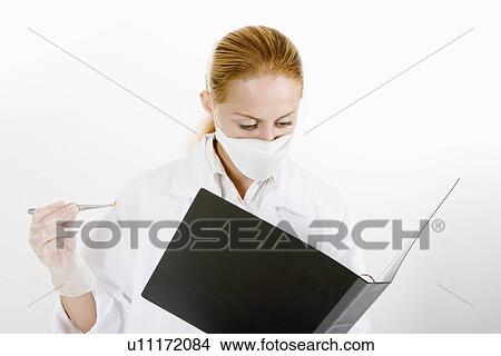 Female scientist looking at document, portrait View Large Photo Image Picture - Female scientist looking at document, portrait. Fotosearch