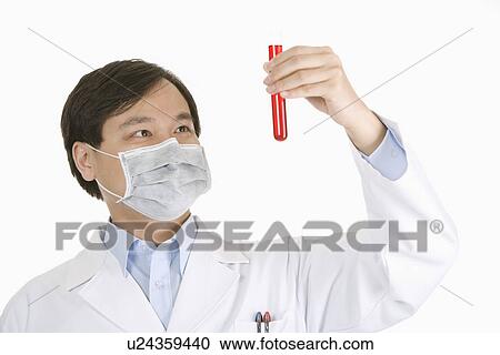 Stock Image - Portrait of a male scientist holding a test tube . Fotosearch