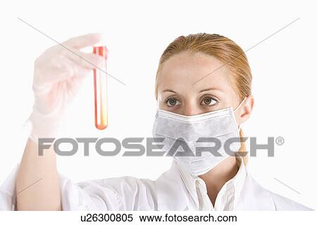 Young woman looking test tube with red liquid, close up View Large Photo Image Stock Photography - Young woman looking test tube with red liquid, close up. Fotosearch