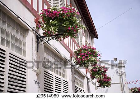 Stock Photo - Houses with flowers hanging outside, Biarritz, South France. Fotosearch