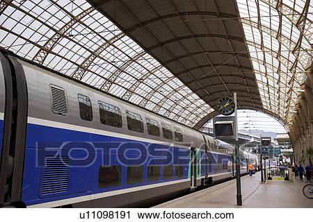 Stock Image - Train and platform in Nice, South France. Fotosearch
