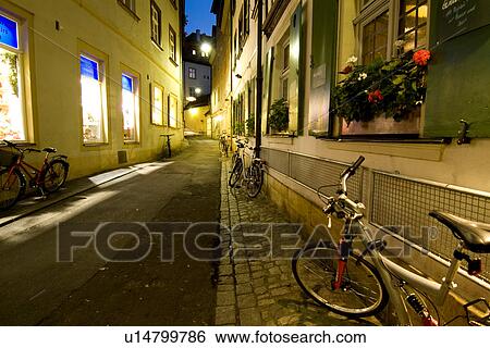 Stock Photograph - Alley with bikes parking aside. Fotosearch