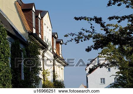 Stock Image - Houses with tree against sky. Fotosearch