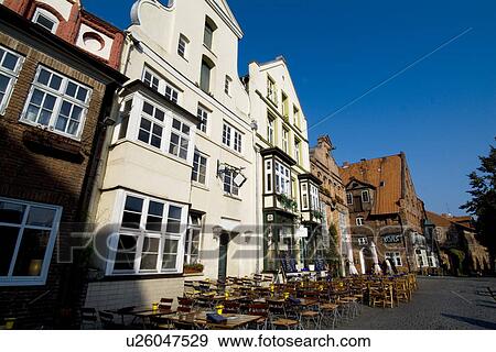 Row of houses with tables and chairs outside View Large Photo Image Stock Photo - Row of houses with tables and chairs outside. Fotosearch