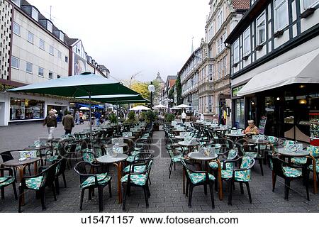 Tables with umbrellas and chairs in an outdoor restaurant in street View Large Photo Image Stock Photo - Tables with umbrellas and chairs in an outdoor restaurant in street. Fotosearch