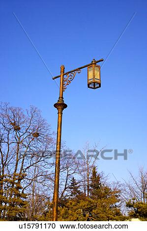 Lantern hanging on pole outdoors View Large Photo Image Stock Image - Lantern hanging on pole outdoors. Fotosearch