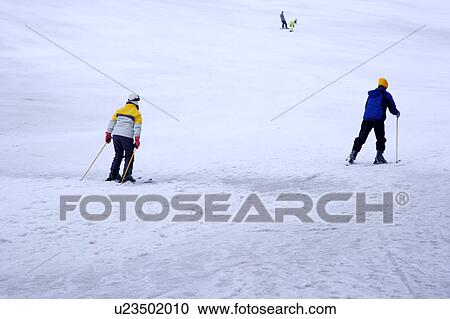 Two persons on ski resort skiing View Large Photo Image Stock Image - Two persons on ski resort skiing. Fotosearch