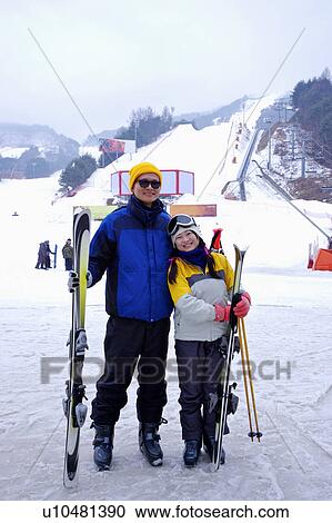 Stock Image - Two persons with ski gear . Fotosearch