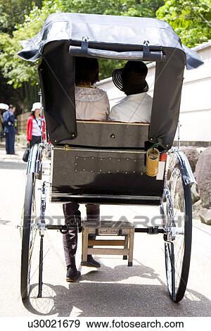 Stock Photo - Rickshaw with two persons. Fotosearch