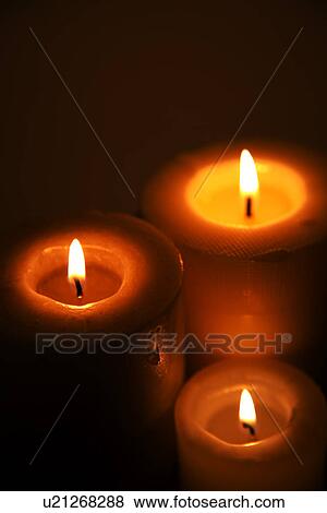 Stock Photo - Lit candles, close-up. Fotosearch