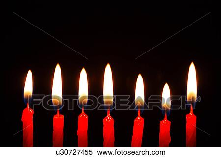 Stock Photography - Lit candles in a row. Fotosearch
