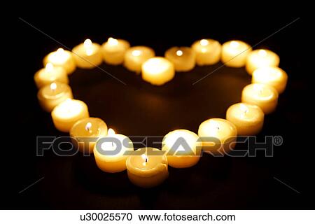 Lit candles in heart shape View Large Photo Image Stock Image - Lit candles in heart shape. Fotosearch