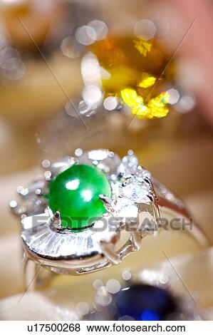 Stock Photo - Diamond rings with jade in box, close-up. Fotosearch