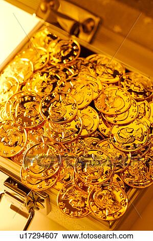 Stock Photo - Golden coins in box, close-up. Fotosearch