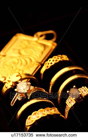 Stock Photography - Golden rings and pendant in box. Fotosearch