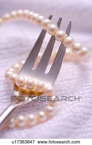 Pearl necklace with fork View Large Photo Image Stock Photo - Pearl necklace with fork. Fotosearch