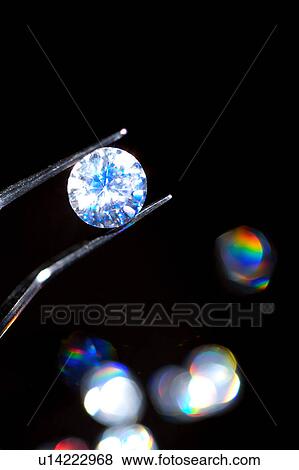 Tweezers with and above diamonds View Large Photo Image Stock Photo - Tweezers with and above diamonds. Fotosearch