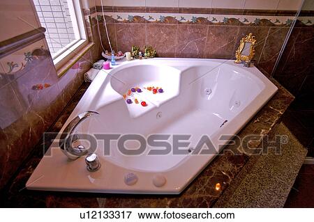 Bathtub with petals by window View Large Photo Image Stock Photo - Bathtub with petals by window. Fotosearch