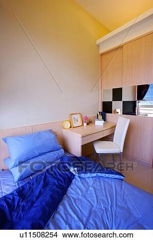 Picture - Bed with table and chair. Fotosearch
