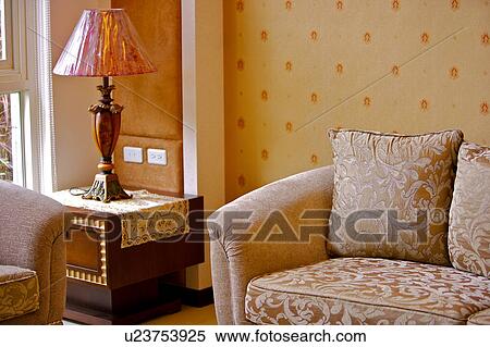 Lamp on side table by sofa View Large Photo Image Stock Photography - Lamp on side table by sofa. Fotosearch