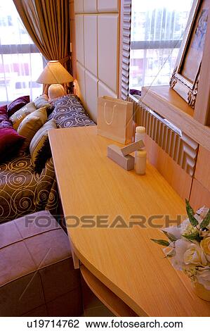 Stock Image - Make-up desk and chair by bed. Fotosearch