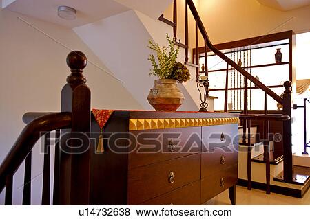 Stock Photo - Potted plants on locker between two staircases. Fotosearch