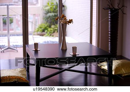 Stock Image - Sitting room with cushions by window. Fotosearch