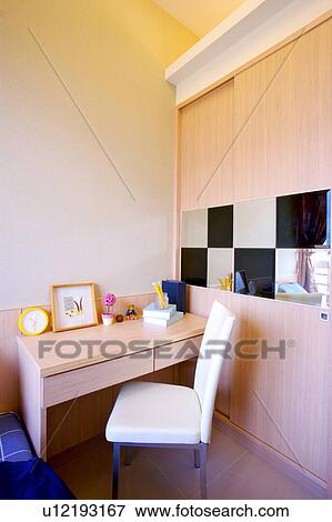 Stock Photo - Table and chair by bed. Fotosearch