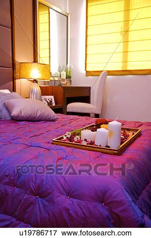 Stock Photo - A tray of flowers and decorations on the bed. Fotosearch
