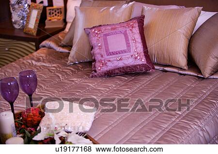 A tray of flowers and goblets on the bed View Large Photo Image Stock Photo - A tray of flowers and goblets on the bed. Fotosearch