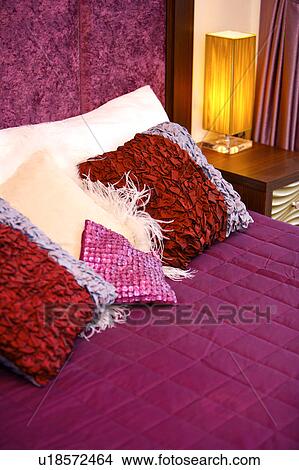 Picture - Decorative pillows on the bed. Fotosearch