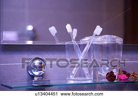 Toothbrushes and decorations on glass shelf in bathroom View Large Photo Image Stock Image - Toothbrushes and decorations on glass shelf in bathroom. Fotosearch