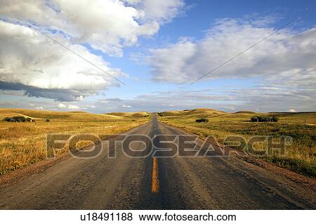 Paved road in rangeland near Robsart, Saskatchewan, Canada View Large Photo Image Stock Photo - Paved road in rangeland near Robsart, Saskatchewan, Canada. Fotosearch