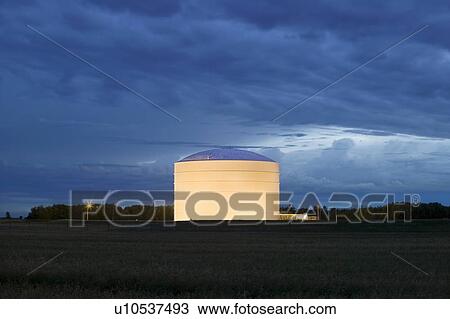 Stock Image - Storage tank in evening light. Fotosearch